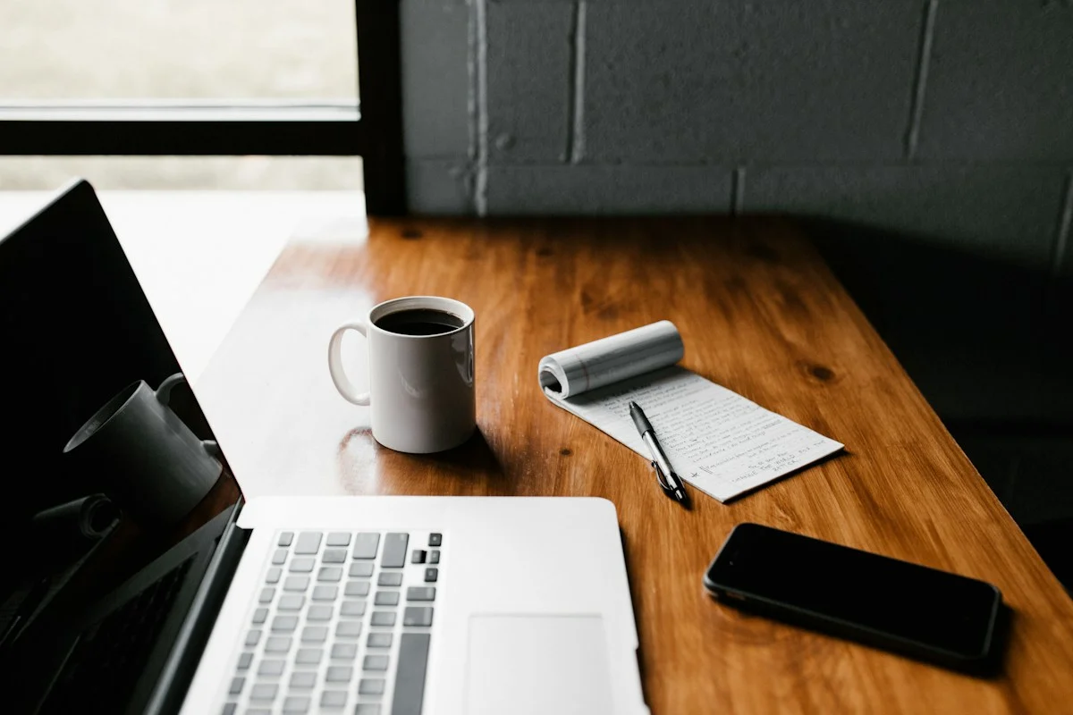 Laptop and coffee on a wooden table